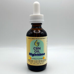 Amber glass dropper bottle of nighttime CBN oil with a citrus label displayed with CBD gummies.