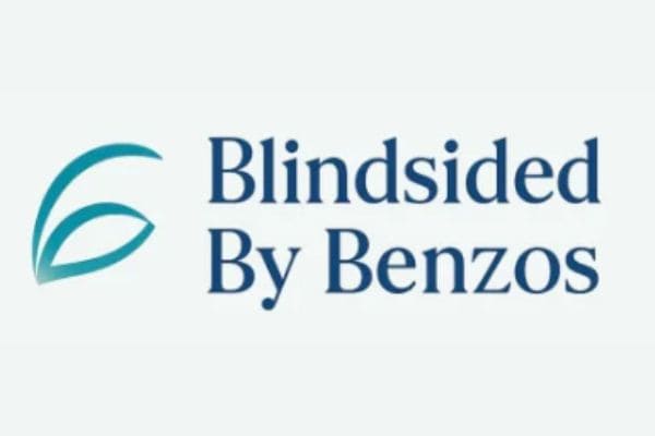 The Blindsided By Benzos logo features a blue abstract leaf icon next to the brand text.